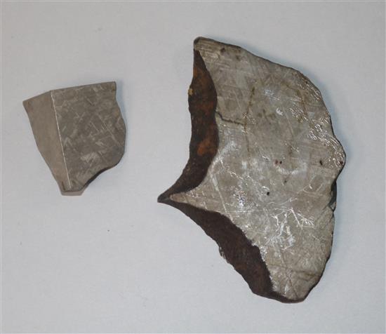 Two meteorite cross sections, largest 3.5in.